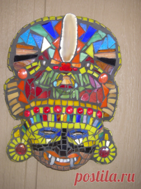 Mosaic Aztec Mask Old mask with agate, stained glass, vitreous glass, and marbles.  This mask hung on a tree in the woods so long it's rope had grown into the tree.  I thought I would give it a new look before returning it.