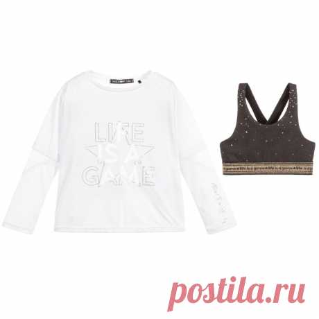 White Sports Top & Bra Set Girls two-piece white sports top and cropped bra set by IKKS. The white jersey top has mesh trims with a gold and white slogan print on the front. The dark grey cropped top is printed with gold stars and has a sparkly gold, elasticated band woven with 'life is a game'.
