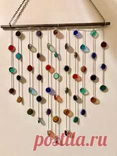 This whimsical and vibrant sun catcher to brighten up any space! The cheery colors will perfectly compliment all seasons and every hint of light will bring a smile to your face. It falls into a lovely shape when hanging. A variety of colors are featured including shades of green, red, purple, amber,