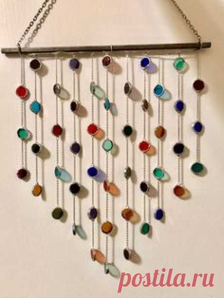 This whimsical and vibrant sun catcher to brighten up any space! The cheery colors will perfectly compliment all seasons and every hint of light will bring a smile to your face. It falls into a lovely shape when hanging. A variety of colors are featured including shades of green, red, purple, amber,