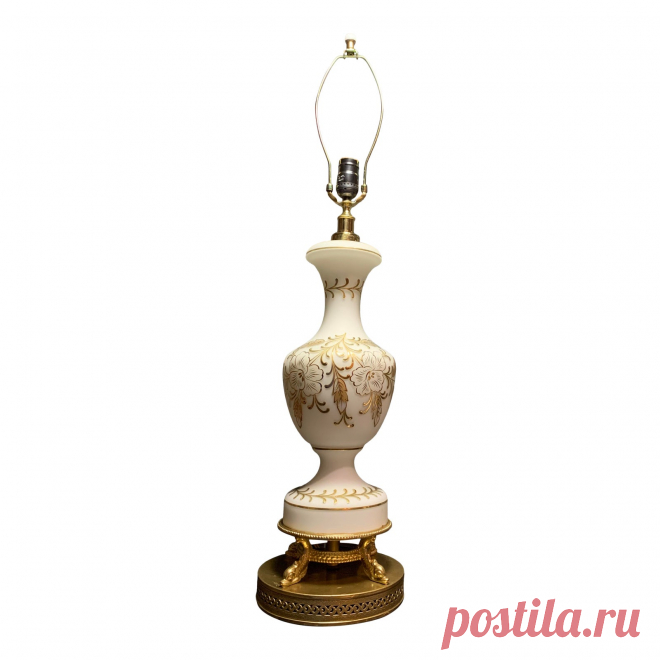 Mid-Century Satin Finish Milk Glass Lamp With Gold Gilded Floral Motif Vintage  Satin Finish Milk Glass  Lamp

Milk glass vase shaped lamp with raised gold  floral motif and scrolled gold accents. 
The lamp is supported by four dolphins mounted upon a perforated round brass base. 

Bulb & shade not included
hgt 22in