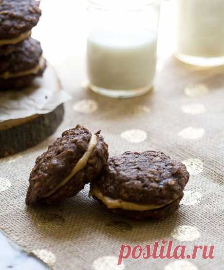 Chocolate Oatmeal Peanut Butter Sandwich Cookies - A Cozy Kitchen Sometimes I want to love what everyone else loves…but don’t. Like, harem pants (my thighs don’t need help looking larger – thanks) or frappuchinos (real coffee, please) or sparkly shoe clips  or Mad Men (boring). Peanut butter and chocolate is one of those things that the entire world LOVES.  And I do, too. It’s the classic of classic combos. And there’s good reason.  Something magical occurs when chocolate ...