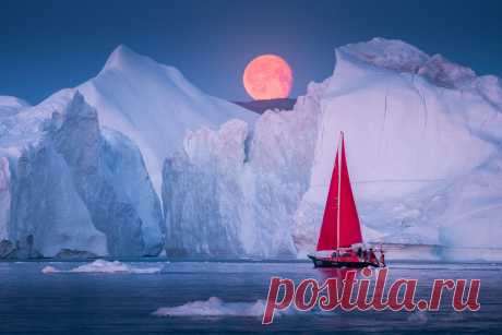 Iced Moon We had great fun in Greenland planning rising moonshots with our 2 little red sail boats. Sailing around the ice fjords at night is magical.