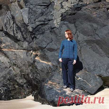 The fitted Selkie cardigan against shoreline textures and rocks