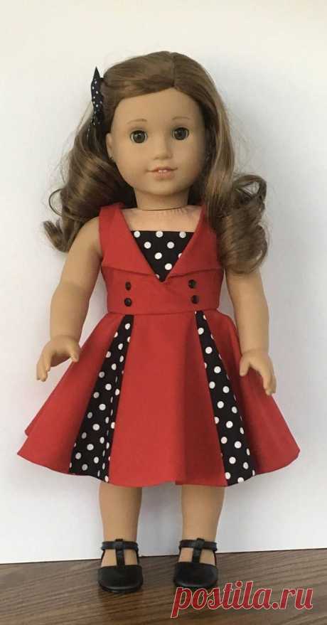 A special dress for your special doll. This dress is made from a red cotton fabric. The bodice is completely lined. The neckline features wide lapels in the front. A black and white polka dot insert is sewn to the front bodice. Four black buttons are hand sewn to the bodice