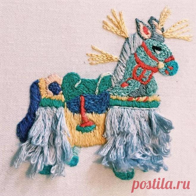 an embroidered horse on a white background