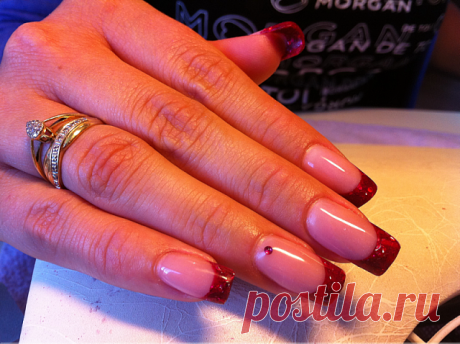Perfect french type wedding manicure with red sequin at the free edge of the nail