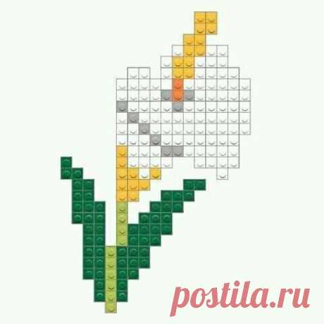 an image of a flower made out of lego blocks with the colors yellow, orange and green
