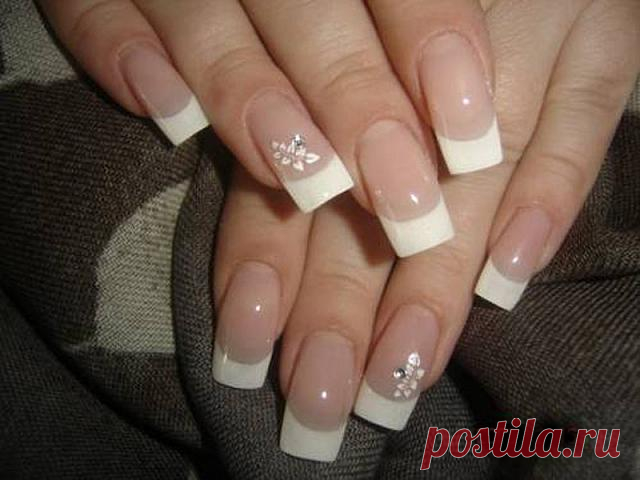 Wedding manicure with french tip nails and beautiful flower ornaments
