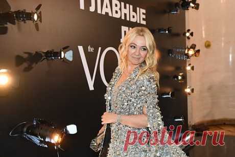 Яна Рудковская вышла в свет в десятикилограммовом наряде. Российский продюсер Яна Рудковская появилась на премии журнала Voice «Главные лица» в наряде весом несколько килограммов. 48-летняя знаменитость вышла в свет в сером мини-платье и длинной черно-серой накидке марки Georges Hobeika. Предметы гардероба были украшены объемными блестящими цветами.