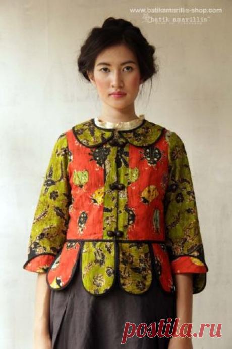 Batik Amarillis' Piccola jacket in jewel colored batik wonogiren -Indonesia ..Take a fresh, sweet & whimsical approach to power dressing with this Krakow-Poland classic traditional folklore inspired jacket . The beauty essential is reworked with a contrast-coloured batiks,unique cuttings ,trims,glossy beaded buttons,it has fitted waist with unique peplum petals.