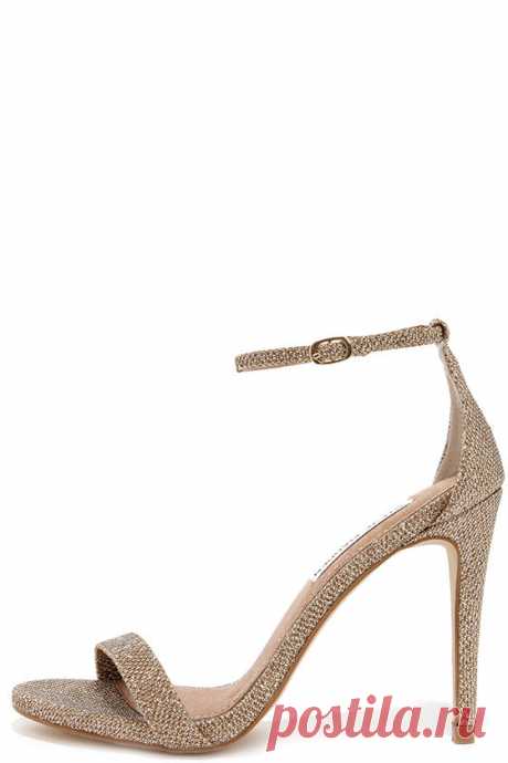 Steve Madden Stecy Gold Fabric Ankle Strap Heels Either with your beau or on your own, wherever you go the Steve Madden Stecy Gold Fabric Ankle Strap Heels will step up your style! These chic high heel sandals are made from glittery gold fabric, with an on-trend single toe band and an adjustable ankle strap (with gold buckle) anchored by a slender heel cup.