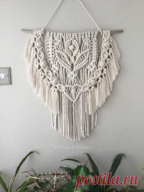 This macrame wall hanging is made with undyed carded soft cotton yarn. It is a natural off white colour and each single twist of cord contains over 20 strands so it drapes well creating a luscious fringe. It hangs from a unique, sea-smoothed piece of driftwood. The driftwood was found along the
