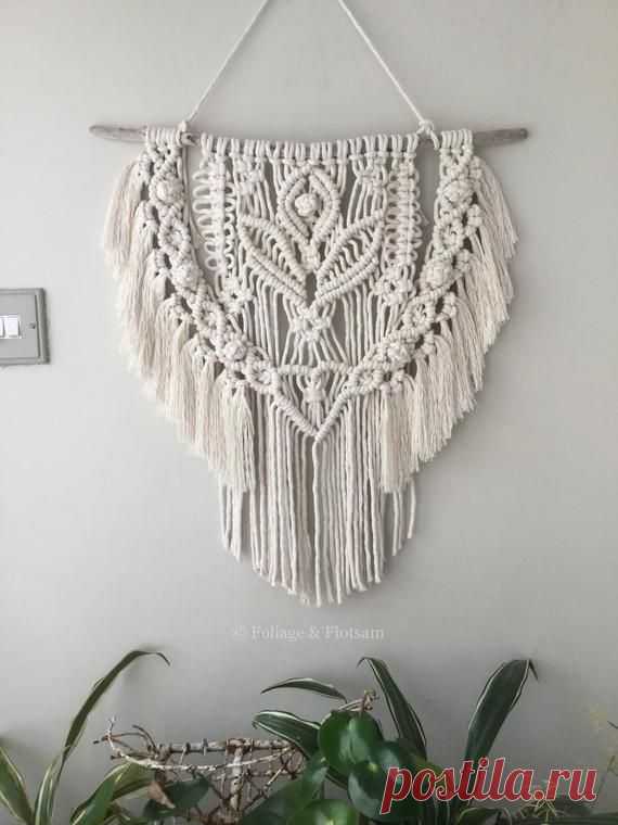 This macrame wall hanging is made with undyed carded soft cotton yarn. It is a natural off white colour and each single twist of cord contains over 20 strands so it drapes well creating a luscious fringe. It hangs from a unique, sea-smoothed piece of driftwood. The driftwood was found along the
