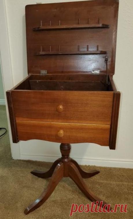 Antique Sewing Table | EstateSales.org Wood sewing box on pedistal. Medium tone wood. Top opens to display spool holders and storage. 23 Tall x 12.5 D x 16