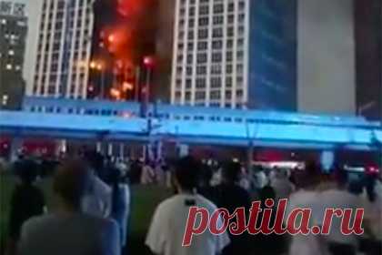 Видео с пожаром в китайском небоскребе попало в сеть. Мощный пожар охватил небоскреб в северо-восточном китайском городе Далянь. По последней информации, огонь тушат 30 экипажей пожарных машин, всего сто человек. Чтобы облегчить работу пожарным, в здании отключили энергоснабжение. Горит жилой блок, однако информации о жертвах не было.