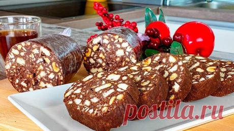 Рецепт из ДЕТСТВА за 10 минут без выпечки. Очень вкусная ШОКОЛАДНАЯ КОЛБАСА Одно из самых простых, но многими любимых блюд. Этот десерт никогда и не с чем не спутаешь. Ингредиенты: печенье, 400 г; молоко, 200 мл; масло сливочное, 150 г; шоколад, 400 г; орехи любые по вашему вкусу, 150 г. Приготовление: Измельчаем печенье в крошку. Орехи обжариваем на сухой сковороде и измельчаем на кусочки. Молоко смешиваем с …