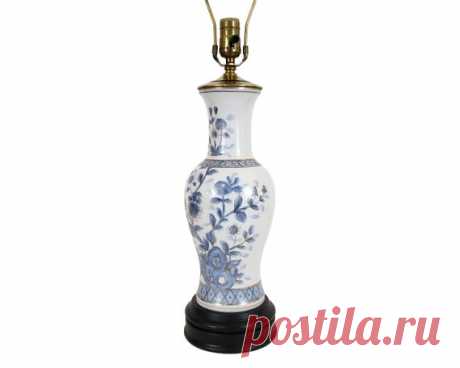 Vintage Asian Blue & White Chrysanthemum Pottery Vase Lamp | Etsy a timeless Kutani porcelain table lamp featuring a hand-painted chrysanthemum motif in pale blue outlined in gold on a crisp white background. the vessel is mounted on a black lacquered base MATERIALS: ceramic, metal, wood  OF THE PERIOD: mid 20th century  PLACE OF ORIGIN: Japan  
$195