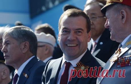 МОСКВА, 9 мая. /ТАСС/. Премьер-министр России Дмитрий Медведев поздравил россиян с 70-й годовщиной Победы в Великой Отечественной войне. &quot;С Днем Великой Победы!&quot; - написал глава правительства на своей страничке в социальной сети Facebook. / Премьер-министр РФ Дмитрий Медведев (в центре) © Алексей Никольский/пресс-служба президента РФ/ТАСС | ТАСС: Общество - Медведев поздравил россиян с Днем Победы и опубликовал фотографии с парада