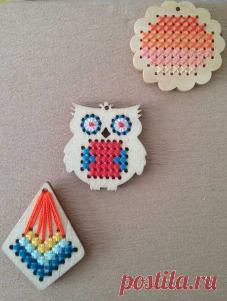 two small pieces of bead art on a table with an owl ornament