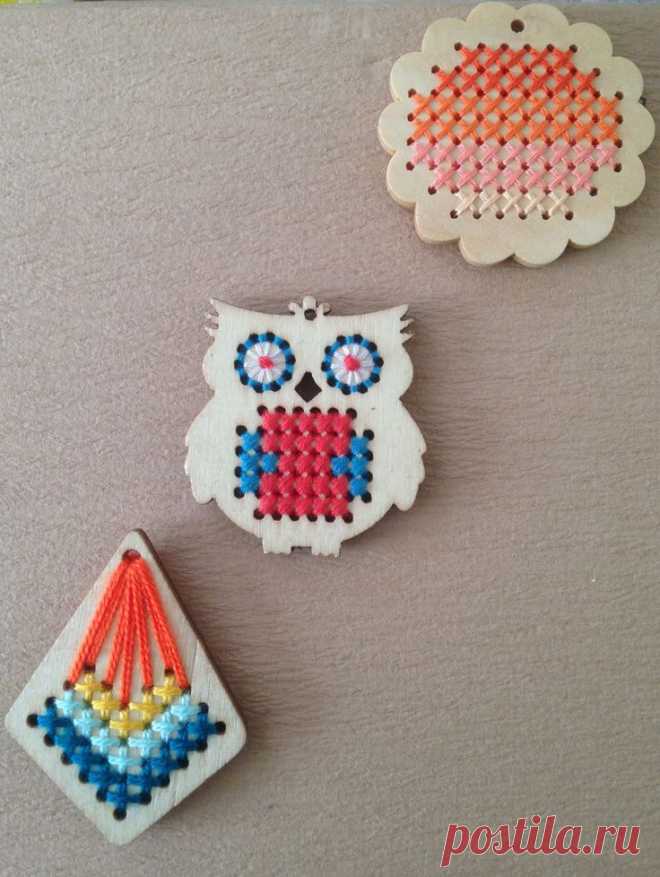 two small pieces of bead art on a table with an owl ornament