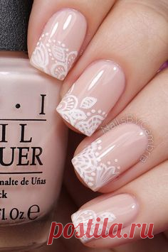 Floral inspired nude nail art. Give life to your nude nails by adding white polish on the tips with flower details on them.