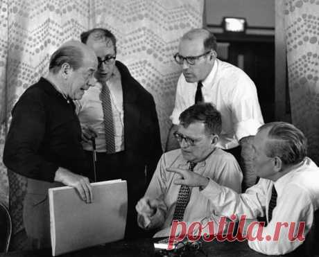From the Philadelphia Orchestra Association Archives:
"In 1959 a touring delegation of Soviet musicians visited Philadelphia for the first recording of Shostakovich’s Cello Concerto No. 1 following its U.S. premiere by the Orchestra and cellist Mstislav Rostropovich; from left to right, Ormandy, Rostropovich, Shostakovich (seated left) with an unidentified interpreter and a recording engineer." 
Photo credit: Adrian Siegel Collection/Philadelphia Orchestra Association Archives