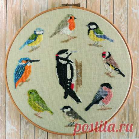 a cross stitch pattern with birds in different colors and sizes on a white background hanging from a wooden hoop