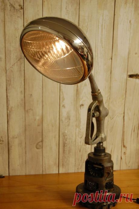 Made from a 32 ford head light, old gas pump handle, and transmission parts.