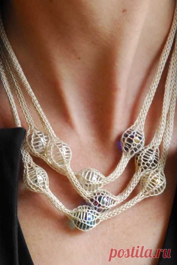 Knitted necklace with marbles caught in a knitting