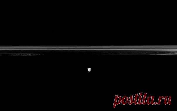 Спутник Сатурна Мимас на фоне колец планеты. Почему кольца выглядят на этом снимке словно урезанными? Все дело в тени, которую отбрасывает на них планета-гигант. Ми́мас, спутник диаметром 396 км, находится ближе, чем кольца / Интересный космос