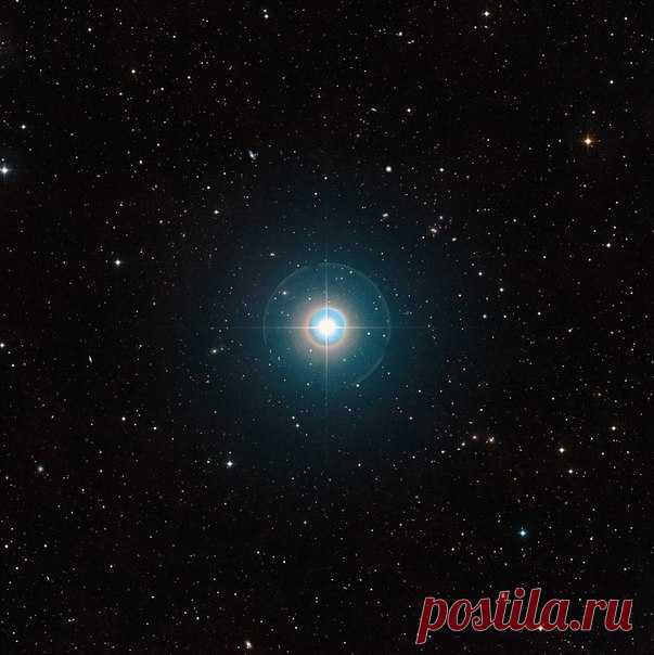 Этот снимок поля вокруг звезды Тау Волопаса взят из обзора Digitized Sky Survey 2. Звезда, которая на небе видна невооруженным глазом находится в центре поля. Лучи и цветные круги вокруг неё искусственные оптические эффекты, связанные с конструкцией телескопа и свойствами фотопластинки. Орбита экзопланеты Тау Волопаса b находится очень близко к звезде и планету на этом снимке заметить невозможно. Её свечение зарегистрировано с помощью телескопа ESO VLT. / Интересный космос