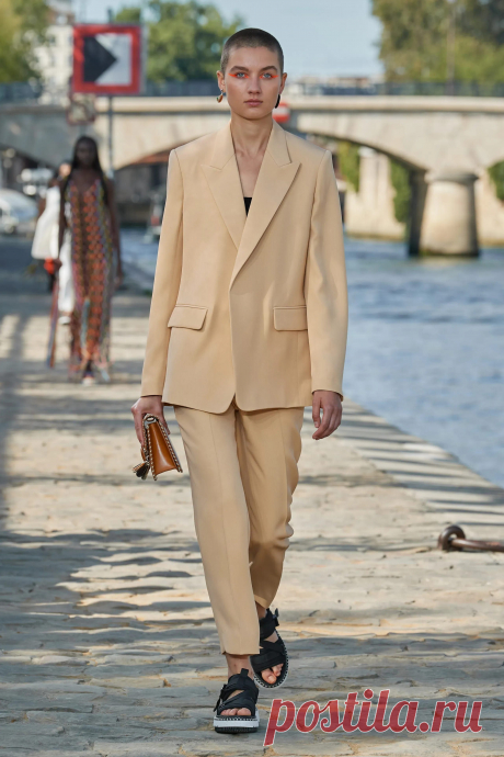 Image may contain Clothing Apparel Suit Coat Overcoat Human Person Jacket Blazer Footwear Shoe and Khaki