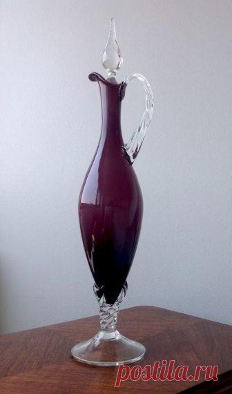 Mid Century Empoli Italian Amethyst Cased Art Glass & Crystal Ewer Decanter  | eBay Stunningly elegant Empoli region Italian mid century ewer/decanter in deep amethyst blown cased glass with twisted crystal base, handle and flame stopper! In great shape but does have one small area of chipping where the top of the handle is applied (see last photo) which is not affecting it's function or usability, and one little rough spot on body of stopper more like a popped bubble. Dis...