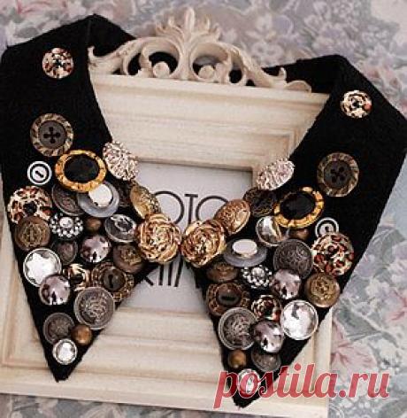 Необычный накладной воротник, расшитый пуговицами и клепками.