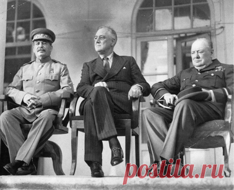 The "Big Three": From left to right: Joseph Stalin, Franklin D. Roosevelt, and Winston Churchill on the portico of the Russian Embassy during the Tehran Conference to discuss the European Theatre in 1943. Churchill is shown in the uniform of a Royal Air Force air commodore.