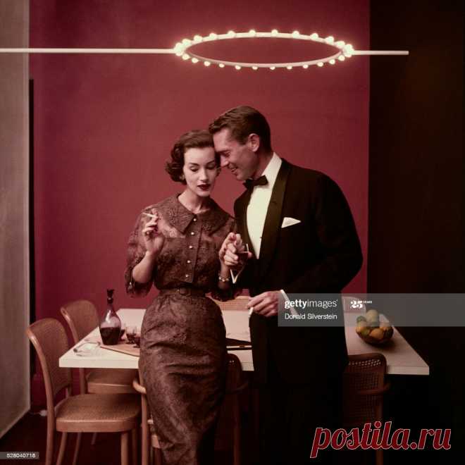 Ruth Neuman Derujinsky is wearing a shirtwaist dress in Chantilly lace with wide collar and sprinkling of rhinestones based on Vogue Pattern, Oct. 1954