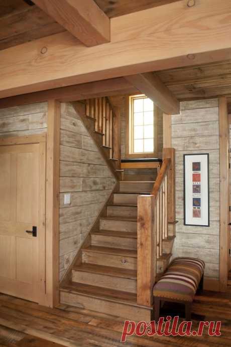 Even the simplicity of this staircase has a way of highlighting the many characteristics of the timber frame hybrid style with the reclaimed flooring and barn boards used for walls.