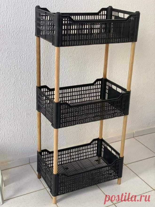a three tiered shelf with baskets on it in front of a white wall and tiled floor
