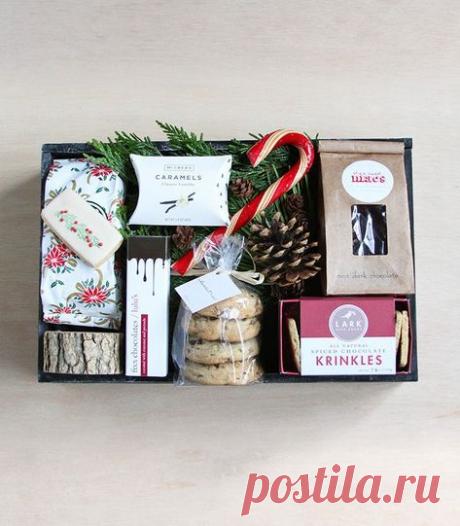 a box filled with cookies, candy and other holiday treats sitting on top of a table