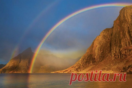 Rainbow's End Lofoten, Norway  You may recognize this mountain if you have seen photo's taken from the bridge at Hamnoy.  I was fortunate to stay in a house at the water's edge here and was treated to a spectacular sunrise on my last morning there.  These scenes happen so quickly, don't they?