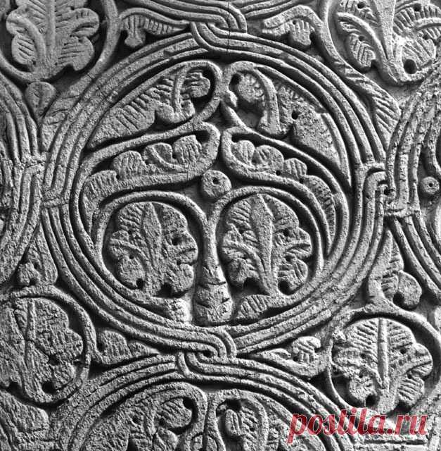 Interior detail showing knotted roundels on arch soffit, containing leaf and flower motifs carved in relief | Archnet