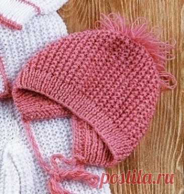 Простая и удобная детская шапочка спицами Наберите розовой нитью 72 п., вяжите 3 см резинкой 1x1. Далее вяжите узором «рис».Узор «рис»: 1-й ряд - вяжите попеременно 1 лиц. п. и 1 изн. п.2-й ряд - все петли лиц. Повторяйте 1-2-й ряды.На высоте шапочки 13 см закройте все петли. Выполните шов от затылочной части на 6 см. Обвяжите...
