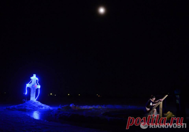Epiphany Bathing in 2014/The water is blessed by the priests before the bathing.
Photo by Konstantin Chalabov. RIA Novosti