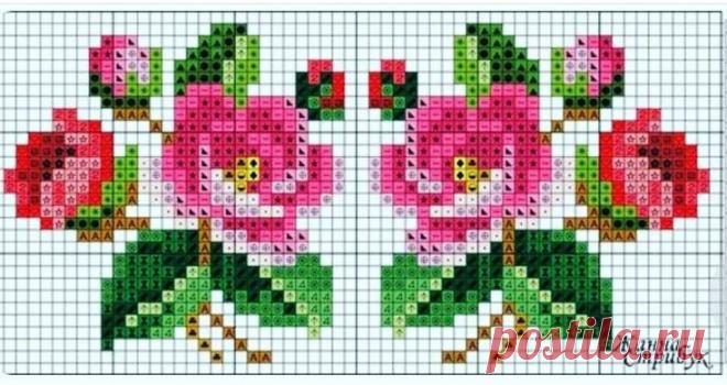 two pink flowers with green leaves are on the cross stitch pattern for a wall hanging
