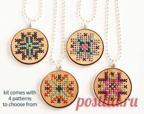 three cross stitch necklaces with four different designs on them and the words kit comes with 4 patterns to choose from