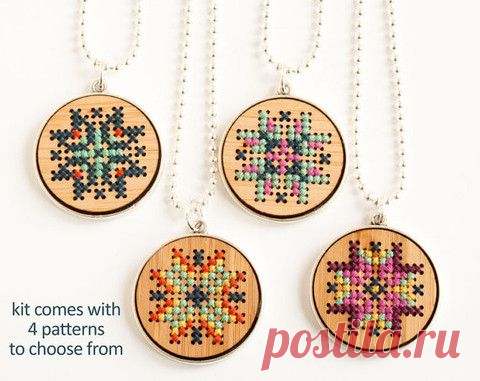 three cross stitch necklaces with four different designs on them and the words kit comes with 4 patterns to choose from