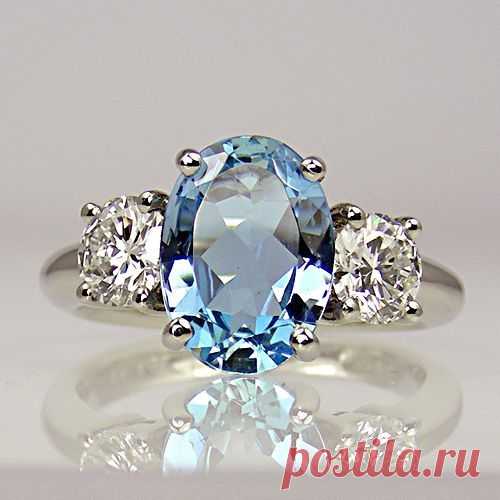 Oval aquamarine with two round brilliant-cut diamonds, one either side, all in claw-collets on platinum shank...simply stunning #aquamarinering