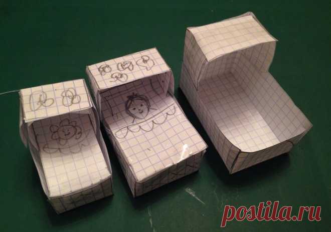 three boxes with drawings on them sitting on a green surface