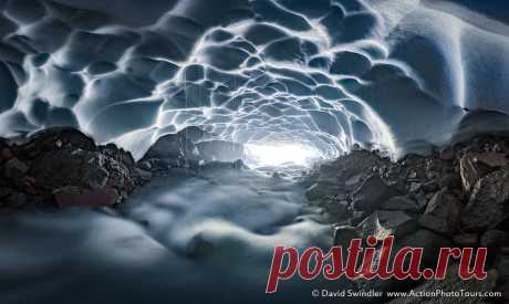 Rushing Enclosure During our visit to Mt Rainier last weekend, we found this snow cave carved out by the rushing flow. Going inside a snow cave can be dangerous and you should have the proper safety equipment. But it is such a surreal experience with the fluted ceiling textures, the drips of water coursing down, and the sound of the rushing stream echoing off the walls.  While snow caves are cool (pun intended), ice caves take the experience to a whole different level! Ima...